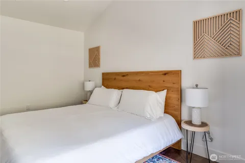 a bedroom with a bed and a lamp