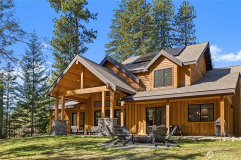 a front view of a house with a yard garage and outdoor seating