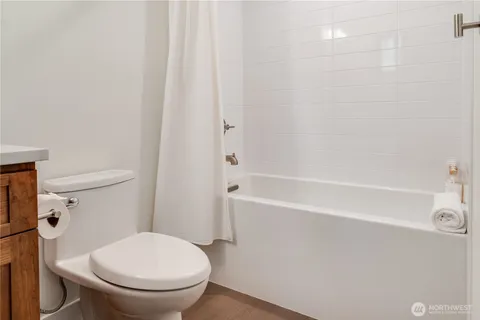 a white toilet sitting next to a bath tub