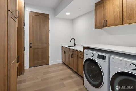 a utility room with sink dryer and washer