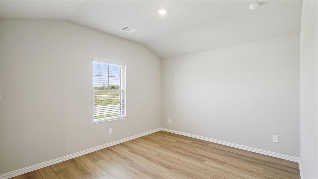 2218 Rannoch Street Sherman, TX 75092 - Photo 14 of 28 an empty room with wooden floor and windows