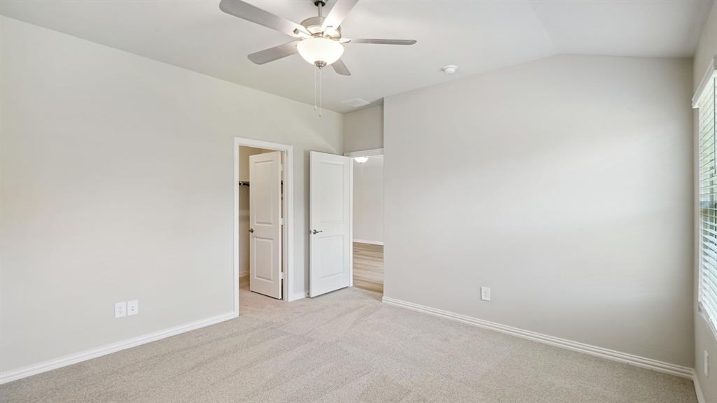2218 Rannoch Street Sherman, TX 75092 - Photo 24 of 28 an empty room with a ceiling fan and a window