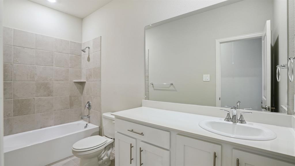 2218 Rannoch Street Sherman, TX 75092 - Photo 26 of 28 a bathroom with a sink a toilet and shower