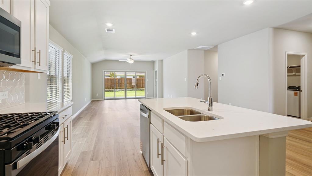 2218 Rannoch Street Sherman, TX 75092 - Photo 6 of 28 a kitchen that has a sink and a stove