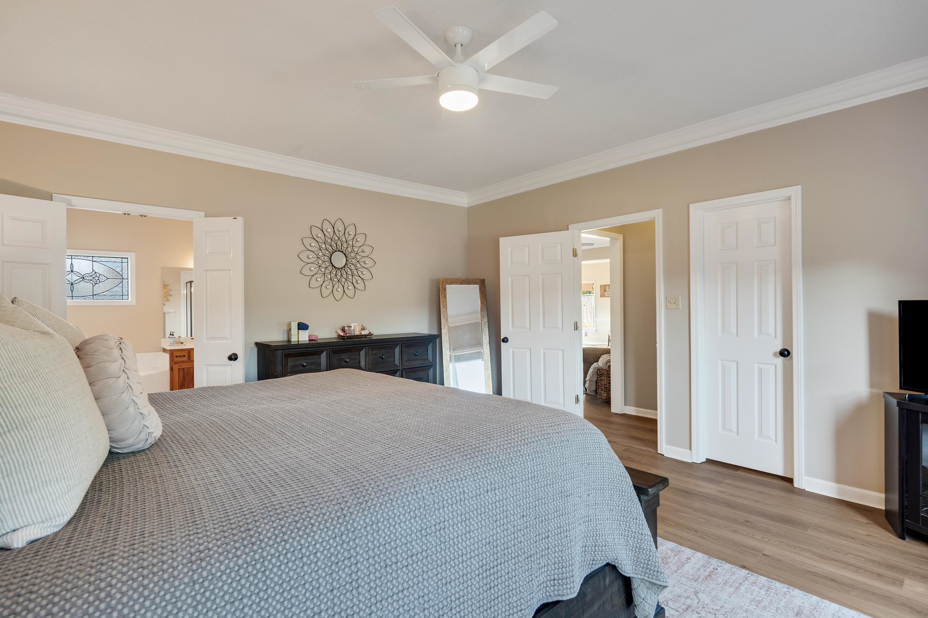 540 Whitney Way Collierville, TN 38017 - Photo 13 of 22 Bedroom with crown molding, light wood-style flooring, a ceiling fan, and connected bathroom