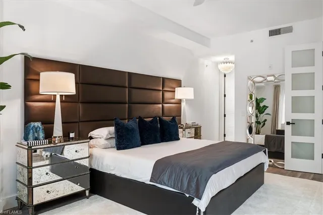 a bedroom with a bed and lamp