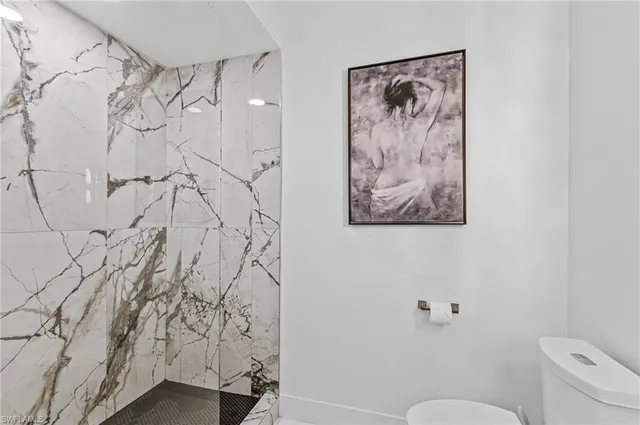 a bathroom with a toilet and a shower curtain