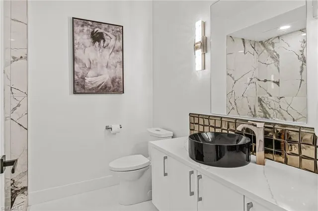 a bathroom with a toilet a sink and view