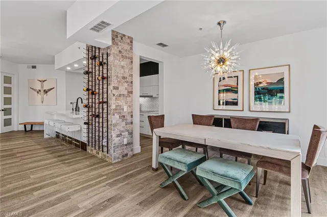 a living room with furniture dining table and a chandelier