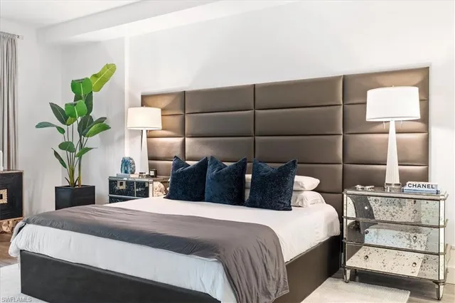 a bedroom with a bed and a potted plant