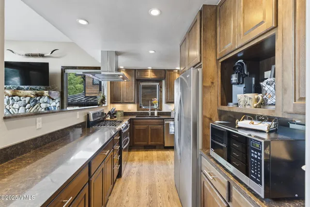 a kitchen with sink stove and cabinets