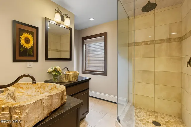 a front view of a house with a flower garden