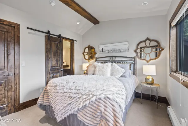 a bedroom with a large bed and a large window