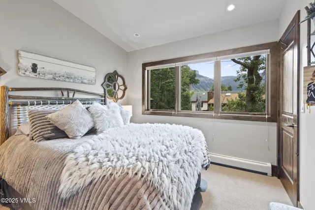 a bathroom with a granite countertop sink toilet and mirror