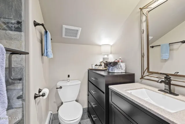 a bedroom with a bed and glass door