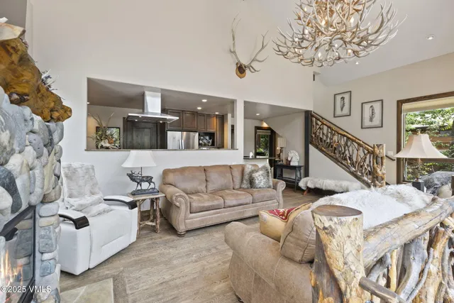 a living room with furniture and a chandelier
