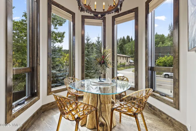 a dining room with furniture window and outside view