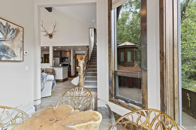 a living room with furniture a fireplace and a floor to ceiling window
