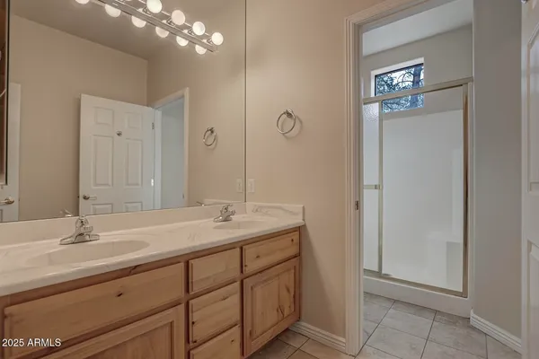 an empty room with windows and ceiling fan