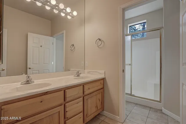 an empty room with windows and ceiling fan