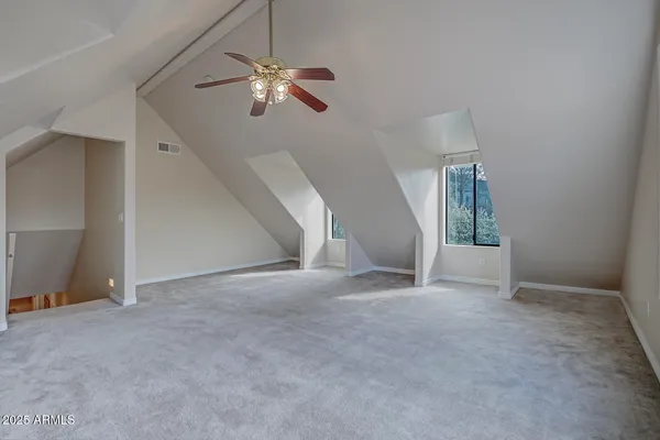 a front view of house with yard and trees in the background