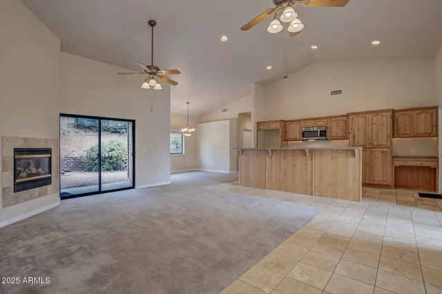 a view of a livingroom with furniture and chandelier fan