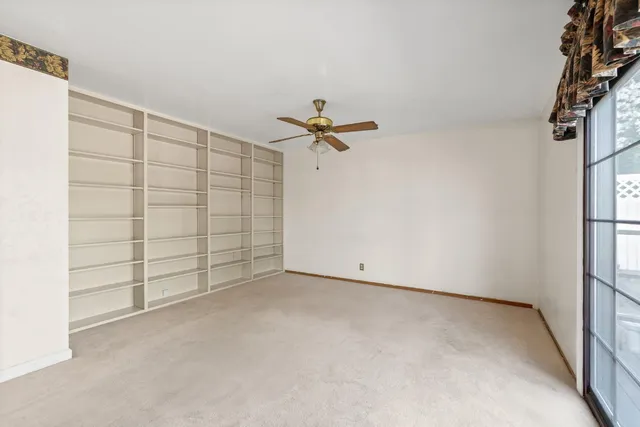a view of a room with cabinet and a ceiling fan