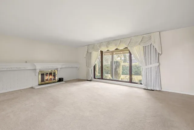 an empty room with windows and city view