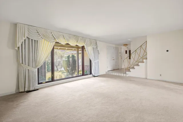 a view of an empty room with stairs