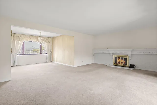 an empty room with entrance and windows