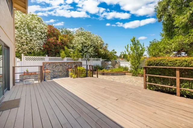 a view of a deck with wooden floor and fence