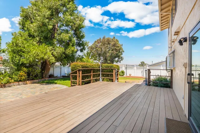 a view of a house with pool and wooden fence