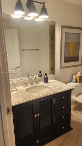 a bathroom with a granite countertop sink a double vanity and a mirror