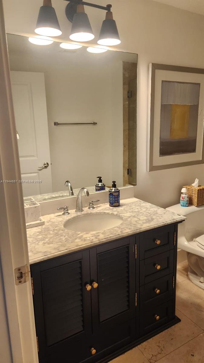 a bathroom with a granite countertop sink a double vanity and a mirror