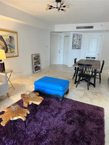 a living room with furniture pool table and a table