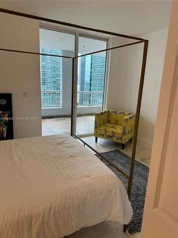 a bedroom with a bed and large window