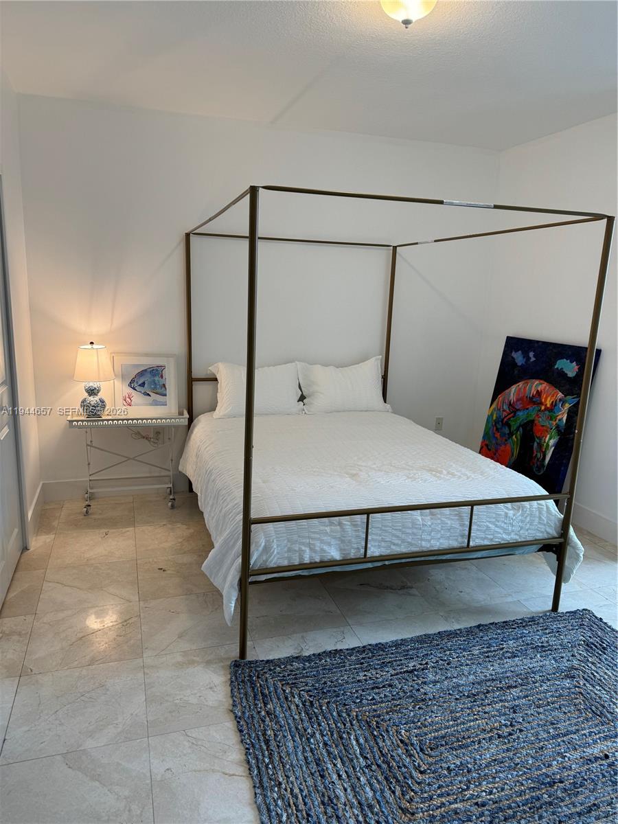 170 Southeast 14th Street, Unit 2405 Miami, FL 33131 - Photo 19 of 25 a bedroom with a bed and a mirror