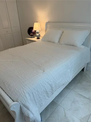 a bedroom with a bed and lamp