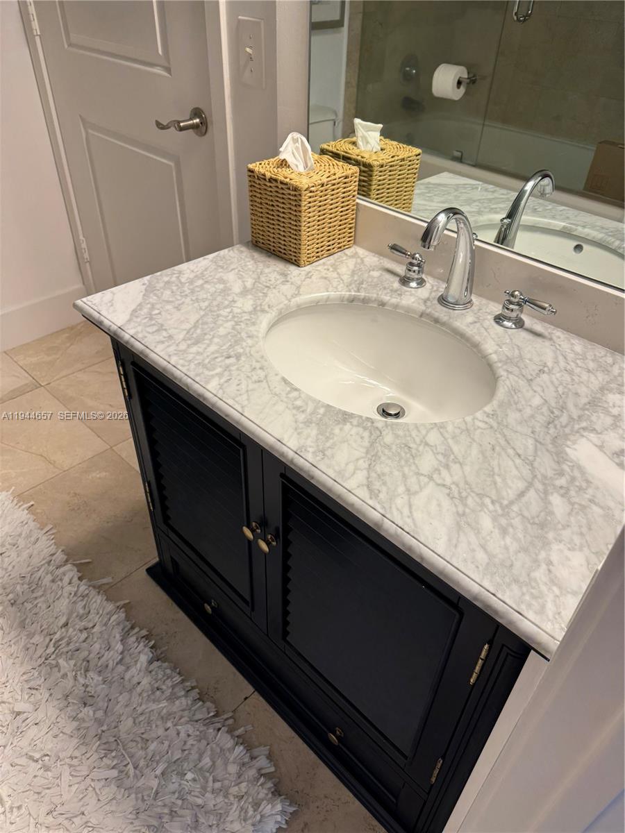 170 Southeast 14th Street, Unit 2405 Miami, FL 33131 - Photo 24 of 25 a bathroom with a sink vanity and a mirror