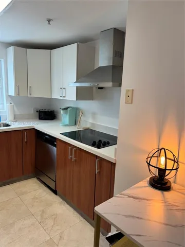 a kitchen with a sink a stove and cabinets