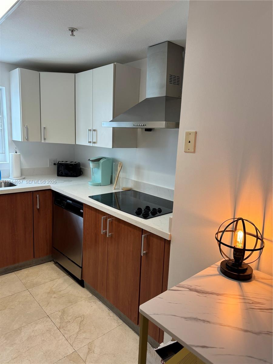 170 Southeast 14th Street, Unit 2405 Miami, FL 33131 - Photo 9 of 25 a kitchen with a sink a stove and cabinets