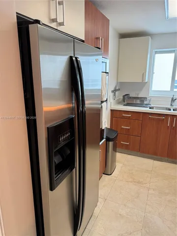 a kitchen with stainless steel appliances a refrigerator and a sink