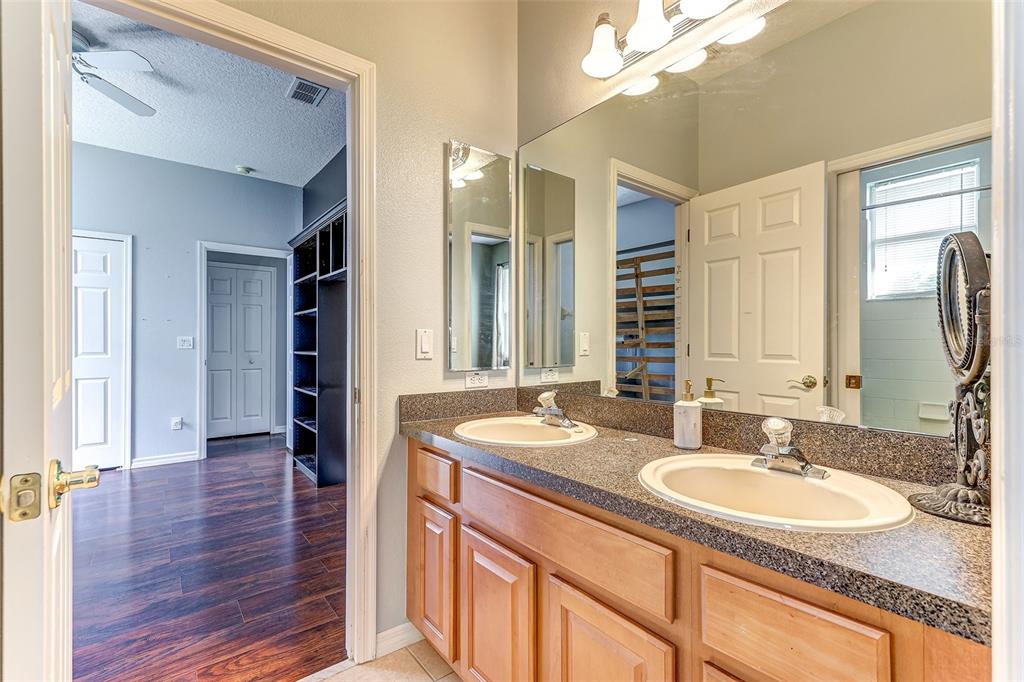 918 Algare Loop Windermere, FL 34786 - Photo 12 of 73 a bathroom with a sink double vanity granite and a mirror