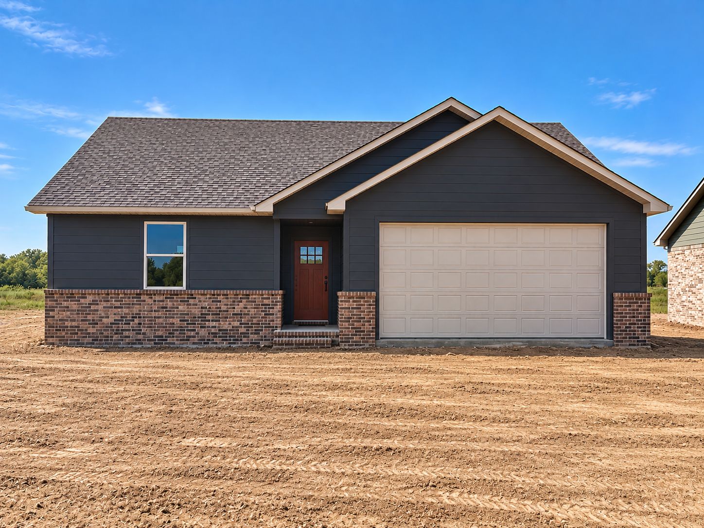 131 Countryside Way Pocola, OK 74902 - Photo 1 of 1 Single-story residence featuring dark siding with brick accents, an attached two-car garage, and a covered entry with a panel door