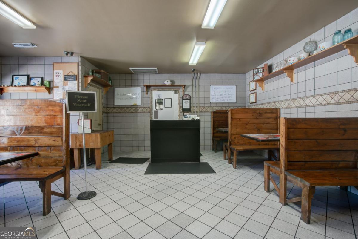 868 County Line Road Resaca, GA 30735 - Photo 11 of 44 a kitchen with a refrigerator and a table