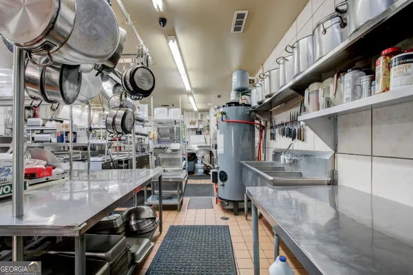 a kitchen with counter top space cabinets and furniture
