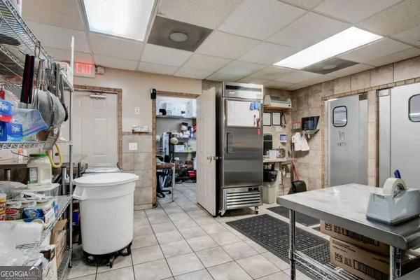 a kitchen with stainless steel appliances granite countertop a refrigerator and a stove
