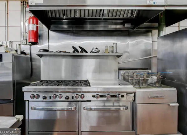 a kitchen with lots of appliances and cabinets