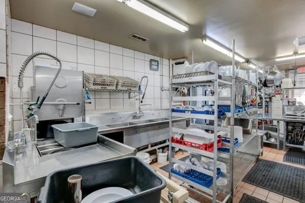 a kitchen with stainless steel appliances granite countertop a sink and cabinets