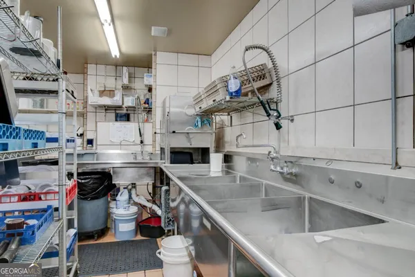 a kitchen with stainless steel appliances kitchen island granite countertop a refrigerator and a stove